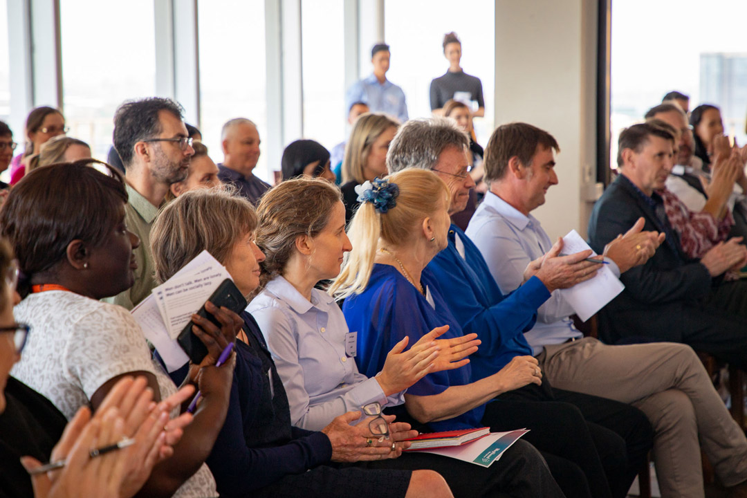 Attendees from a WayAhead Workplaces meeting clapping